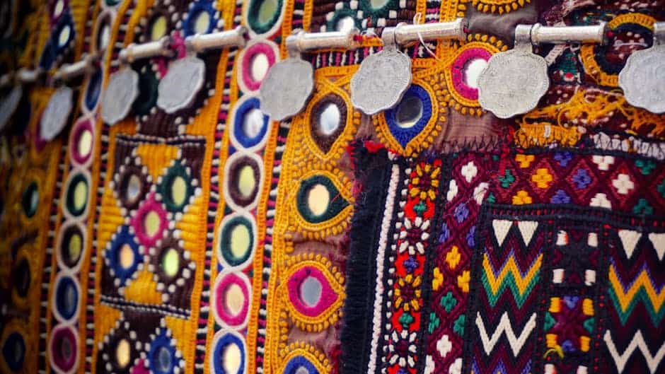 Vibrant embroidered textile artwork with colorful patterns and intricate details for Rivercity Screenprinting.